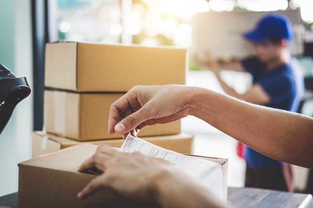 A packing slip is getting put onto a package